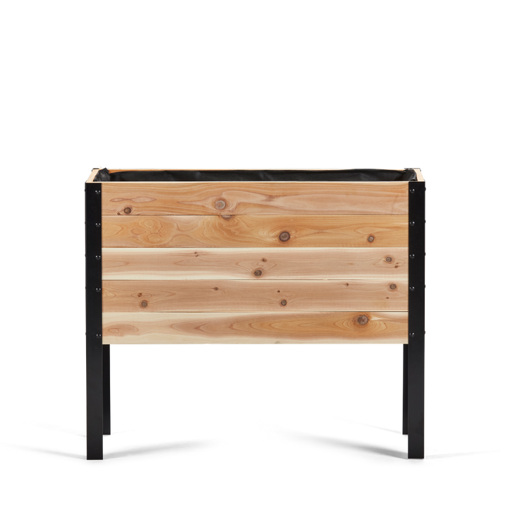 Wooden planter box with black metal frame on a white background