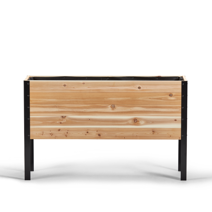 Wooden planter box with black metal frame on a white background